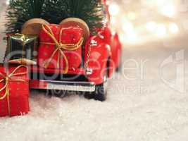 Winter scene with red Christmas truck and gift boxes