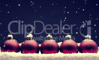 Old used red Christmas baubles with snow