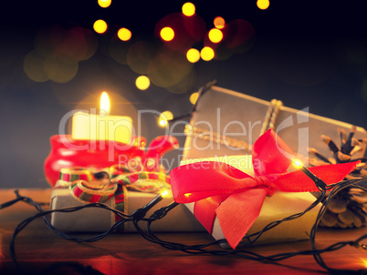 Magical Christmas background with gift boxes and candle