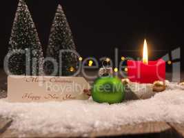 Christmas greetings with a vintage bauble and candle light
