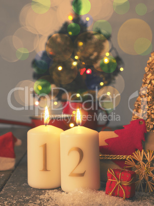 Two Advent candles burning with gift boxes, vintage tone stylize