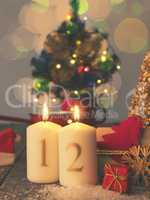 Two Advent candles burning with gift boxes, vintage tone stylize