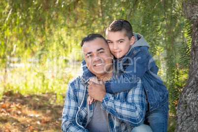 Portrait of Mixed Race Father And Son Having Fun Outdoors