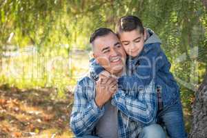 Portrait of Mixed Race Father And Son Having Fun Outdoors