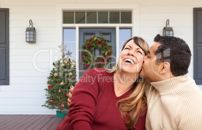 Hispanic and Caucasian Young Adult Couple On Christmas Decorated