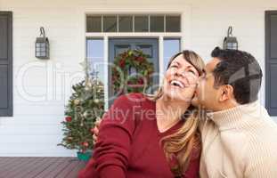 Hispanic and Caucasian Young Adult Couple On Christmas Decorated