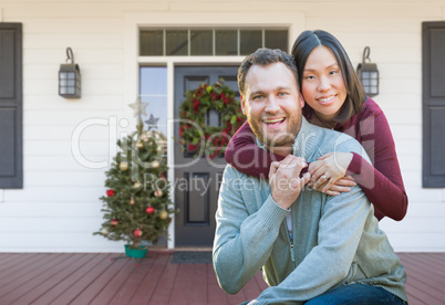 Chinese and Caucasian Young Adult Couple On Christmas Decorated