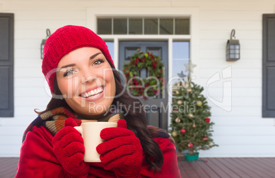 Young Girl Wearing Scarf, Red Cap and Mittens with Hot Cocoa Mug