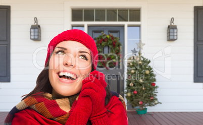 Young Girl Wearing Scarf, Red Cap and Mittens Standing on Christ