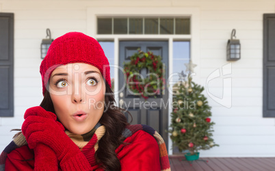 Young Girl Wearing Scarf, Red Cap and Mittens Standing on Christ