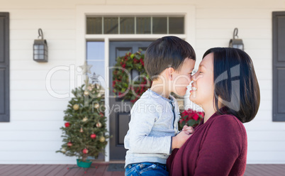 Chinese Mother and Mixed Race Child Rubbing Noses Standing on Ch