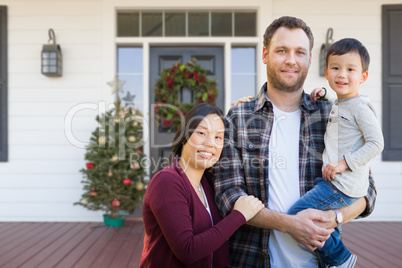 Mixed Race Chinese and Caucasian Parents with Child On Christmas