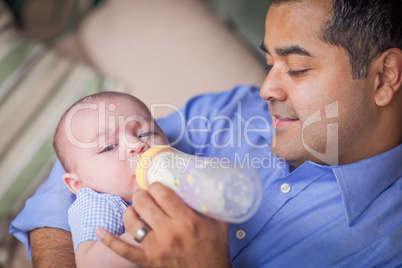 Happy Hispanic Father Bottle Feeding His Very Content Mixed Race