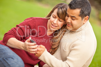 Attractive Mixed Race Couple Enjoying Their Camera Phone in the