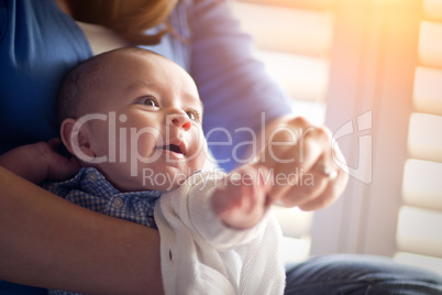 Happy Mixed Race Couple Enjoying Their Newborn Son In The Light