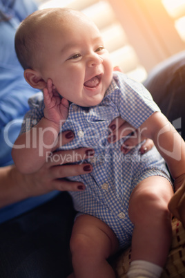 Happy Mixed Race Couple Enjoying Their Newborn Son In The Light