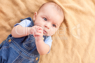 Happy Mixed Race Baby Boy Laying on Blanket
