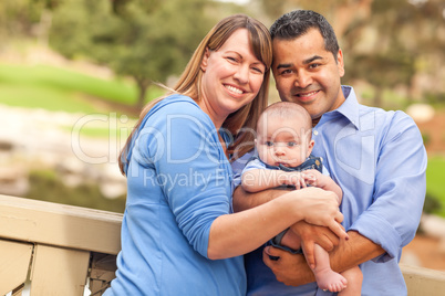 Happy Mixed Race Family Posing for A Portrait in the Park