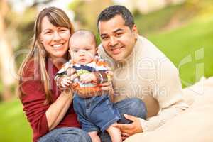 Happy Mixed Race Family Posing for A Portrait in the Park