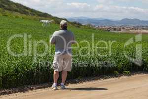 Pilot Flying Unmanned Aircraft Drone Gathering Data Over Country