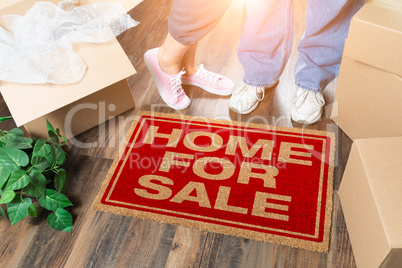 Man and Woman Standing Near Home For Sale Welcome Mat, Moving Bo