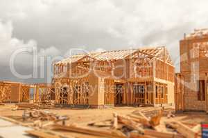 Wood Home Framing Abstract At Construction Site with Stormy Clou