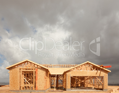 Wood Home Framing Abstract At Construction Site with Stormy Clou