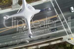 Unmanned Aircraft System Quadcopter Drone In The Air Over Roadwa