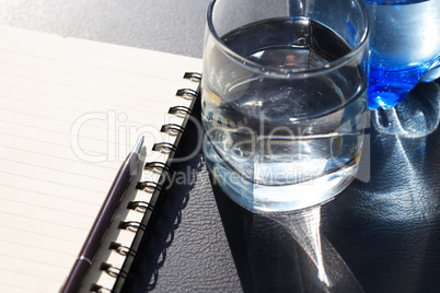Glass Of Water Near Notepad