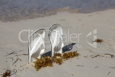 White sandals. White sandals on the beach