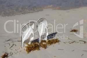 White sandals. White sandals on the beach