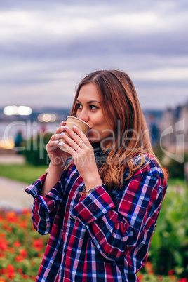 Beautiful young woman drinking coffee