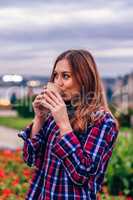 Beautiful young woman drinking coffee