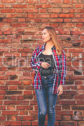 Portrait of young woman in shirt and jeans