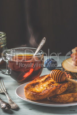 French toasts with honey, fruits and tea