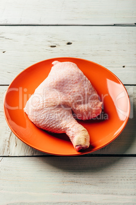 Chicken leg on orange plate