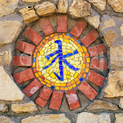 Mosaic religious symbol on wall.