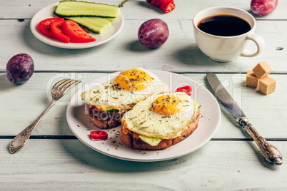 Bruschettas with vegetables and fried egg, cup of coffee and som