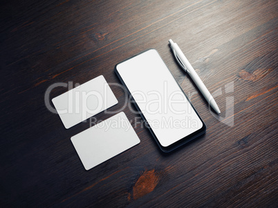 Smartphone, business cards, pen