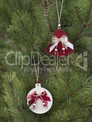 Traditional christmas hand made decoration hanging on fir tree.