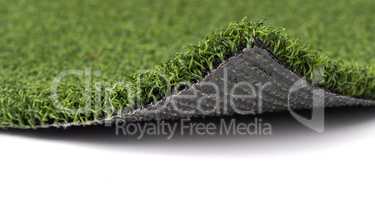 Flipped Up Section of Artificial Turf Grass On White Background