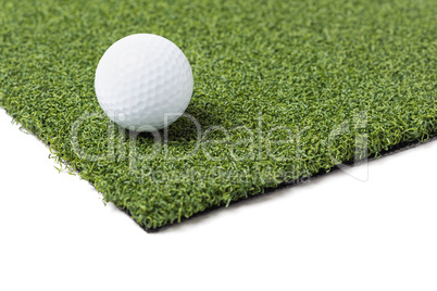 Golf Ball Resting on Section of Artificial Turf Grass On White B
