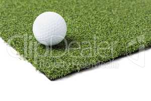 Golf Ball Resting on Section of Artificial Turf Grass On White B