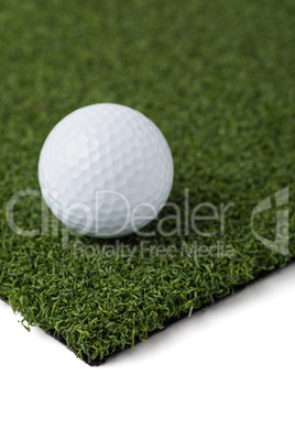 Golf Ball Resting on Section of Artificial Turf Grass On White B