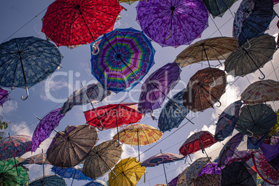 Colored umbrellas suspended in the air