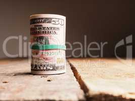 Many Dollar banknotes on a wooden table