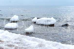 the sea is frozen, pierce in the ice, the sea coast in the ice winter on the Baltic sea, icing on the seafront