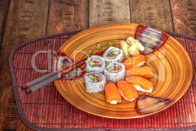 Salmon sushi rolls and sake with wasabi