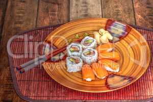 Salmon sushi rolls and sake with wasabi