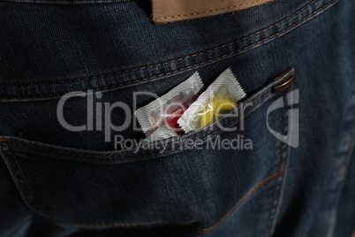 packaging with a condom in jeans pocket